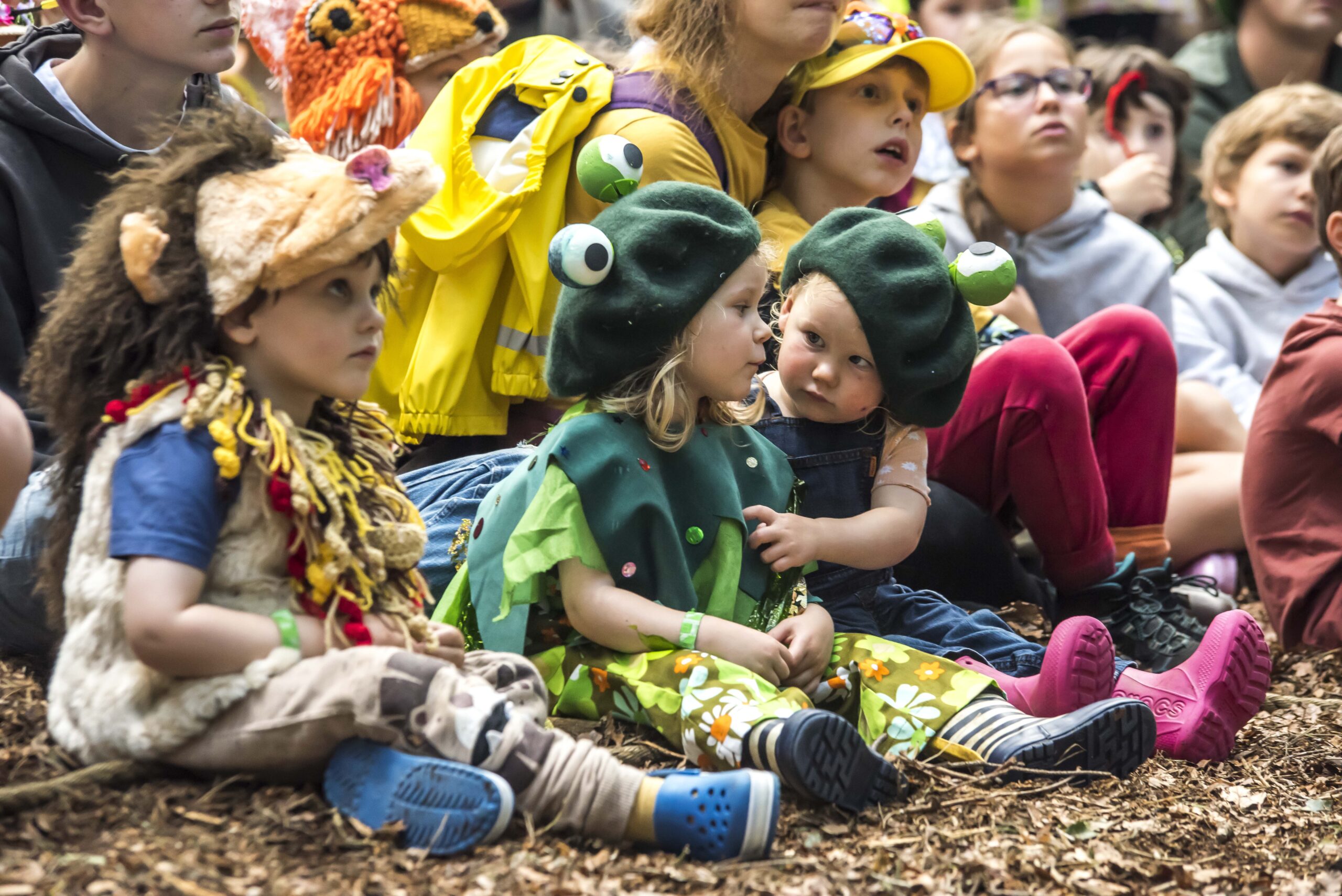 Two small girls dressed as frogs at Just So Festival.