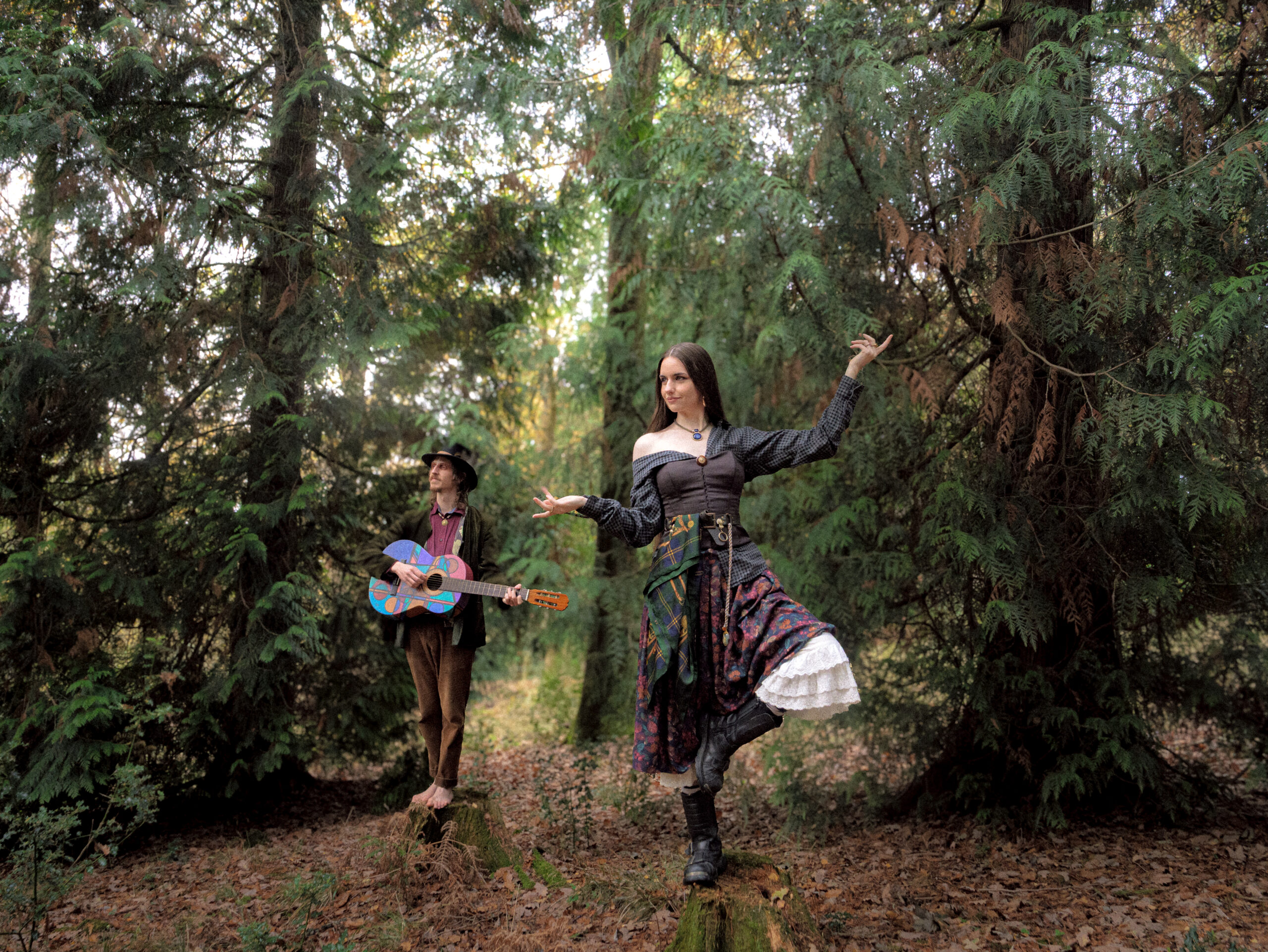 The duo, Nastee Chapel, posing in the forest in folky costumes